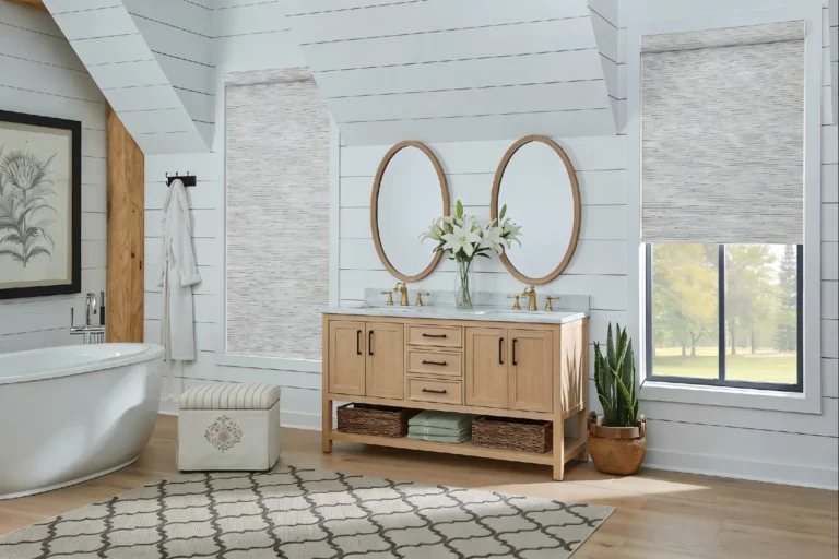Stylish bathroom featuring a freestanding bathtub, double vanity with oval mirrors, wooden cabinetry, and decorative plants.