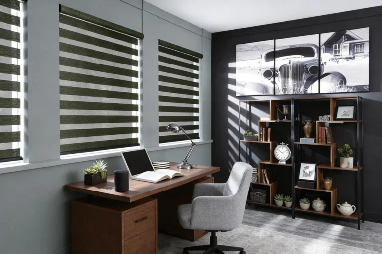 Home office featuring a wooden desk, chair, laptop, book, and modern shelf with decor items. Black and white car art on the wall.