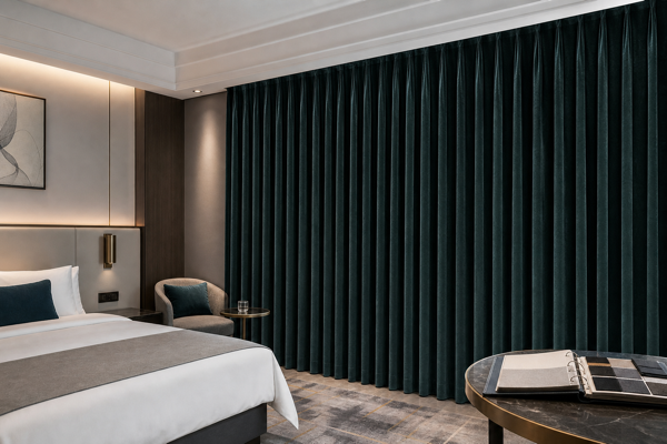 Fully closed deep teal blackout curtains in a hotel procurement mock-up