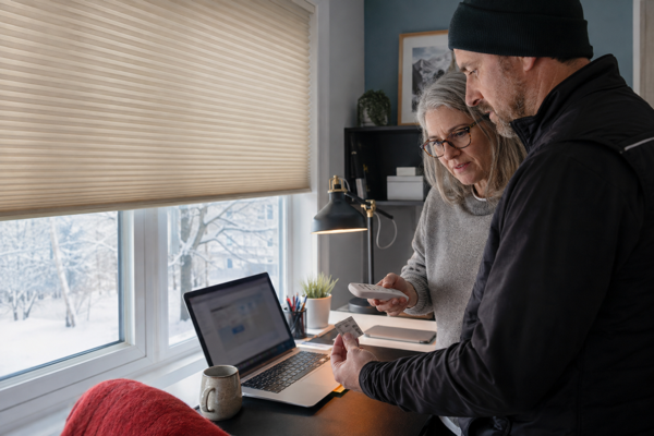 A Canadian homeowner and technician checking the radio label for an ivory cellular shade